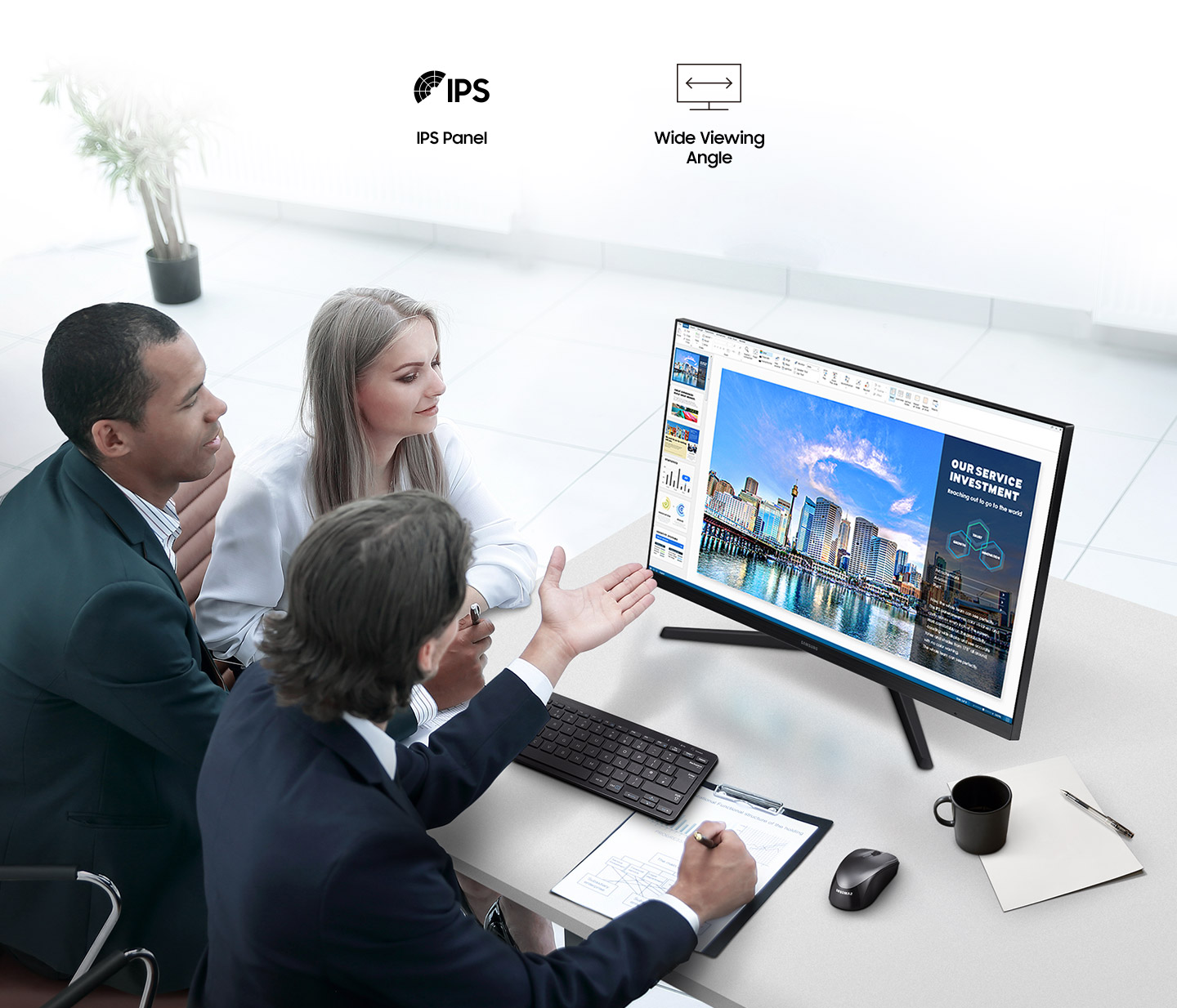 There are IPS Panel and Wide Viewing Angle icons. Three people are sitting around the monitor with the monitor in the middle, looking at the monitor and having a conversation.